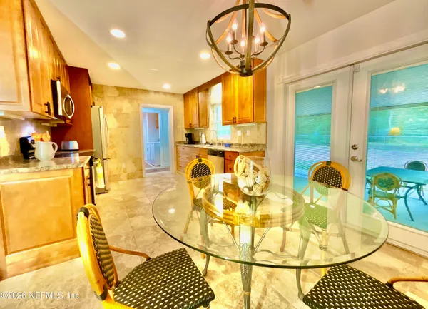 a view of a swimming pool with a dining table chairs and couches