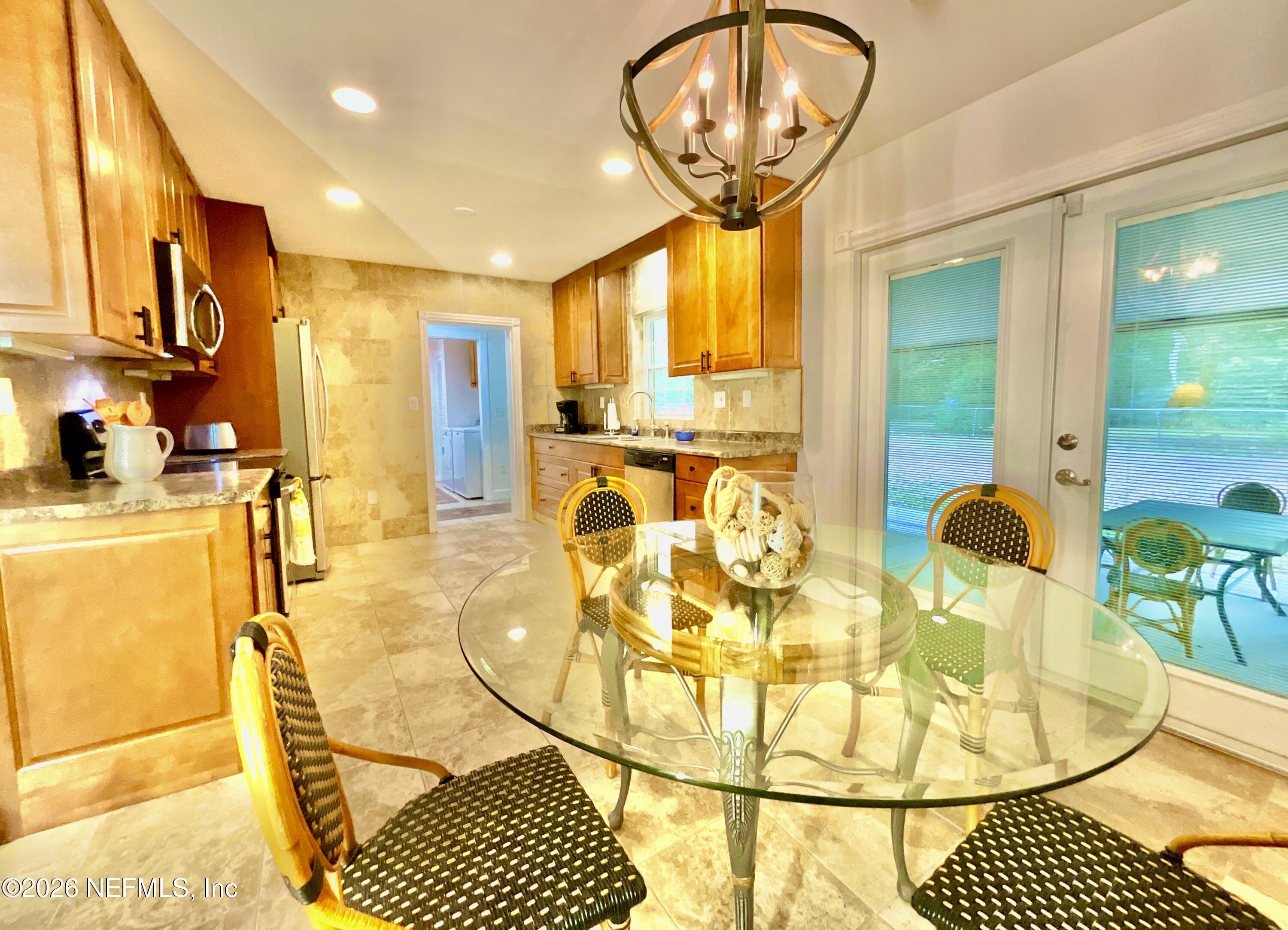 17221 Northeast 77th Lane Hawthorne, FL 32640 - Photo 24 of 59 a view of a dining room with furniture and chandelier