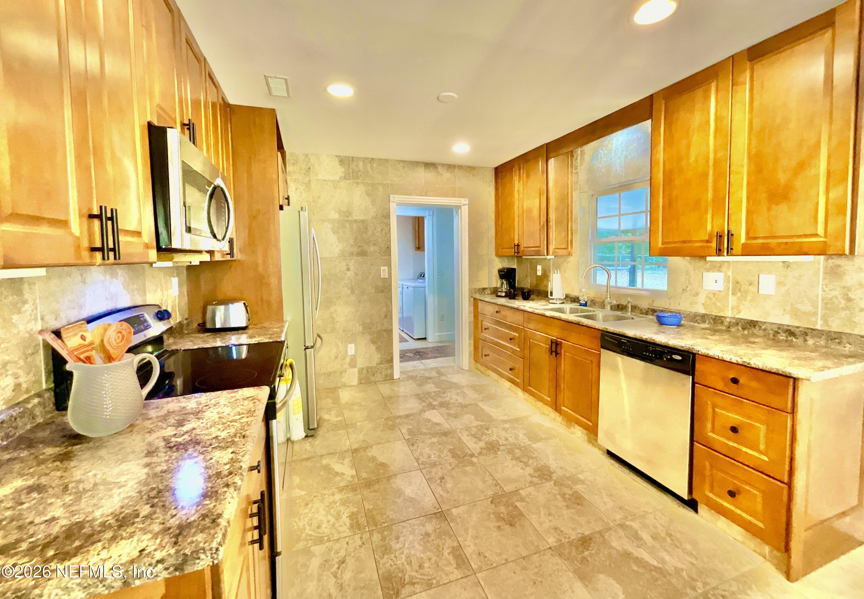 17221 Northeast 77th Lane Hawthorne, FL 32640 - Photo 25 of 59 a large white kitchen with a large window