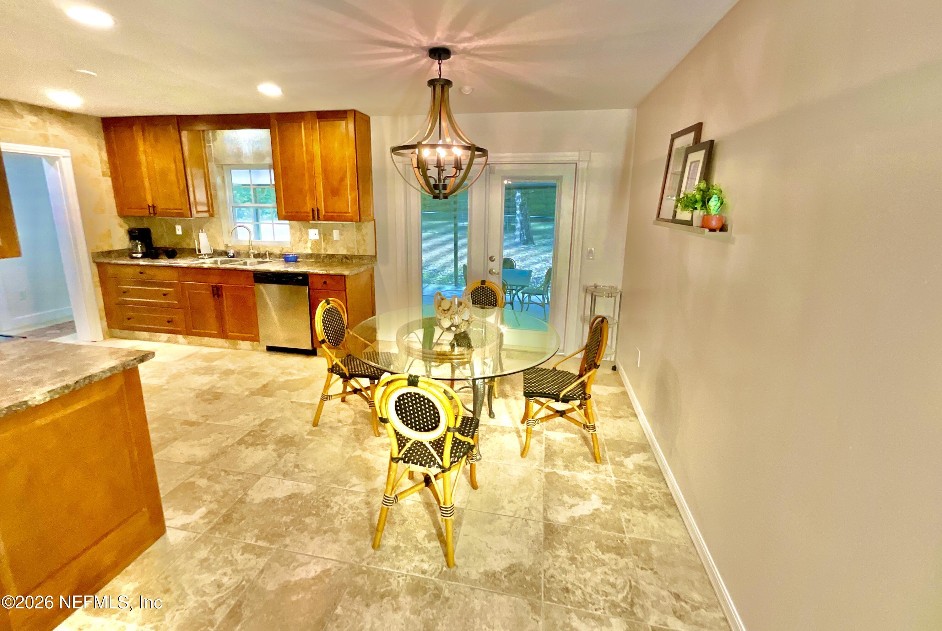 17221 Northeast 77th Lane Hawthorne, FL 32640 - Photo 27 of 59 a view of a swimming pool with a dining table chairs and couches