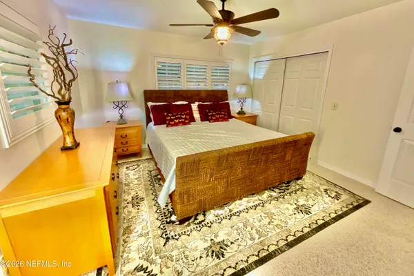 a bed sitting in a bedroom next to a window