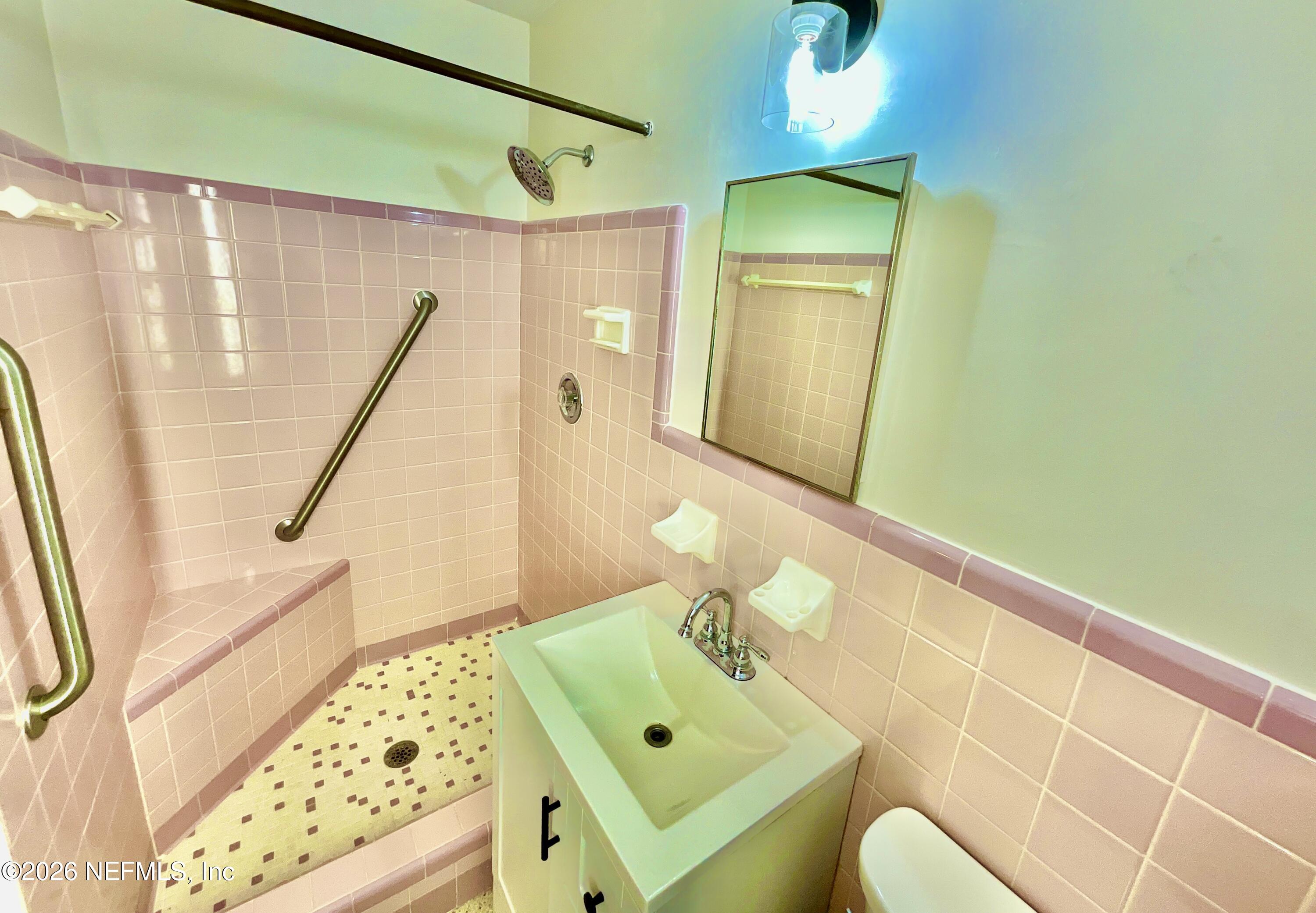 17221 Northeast 77th Lane Hawthorne, FL 32640 - Photo 30 of 59 a bathroom with a sink mirror vanity and toilet