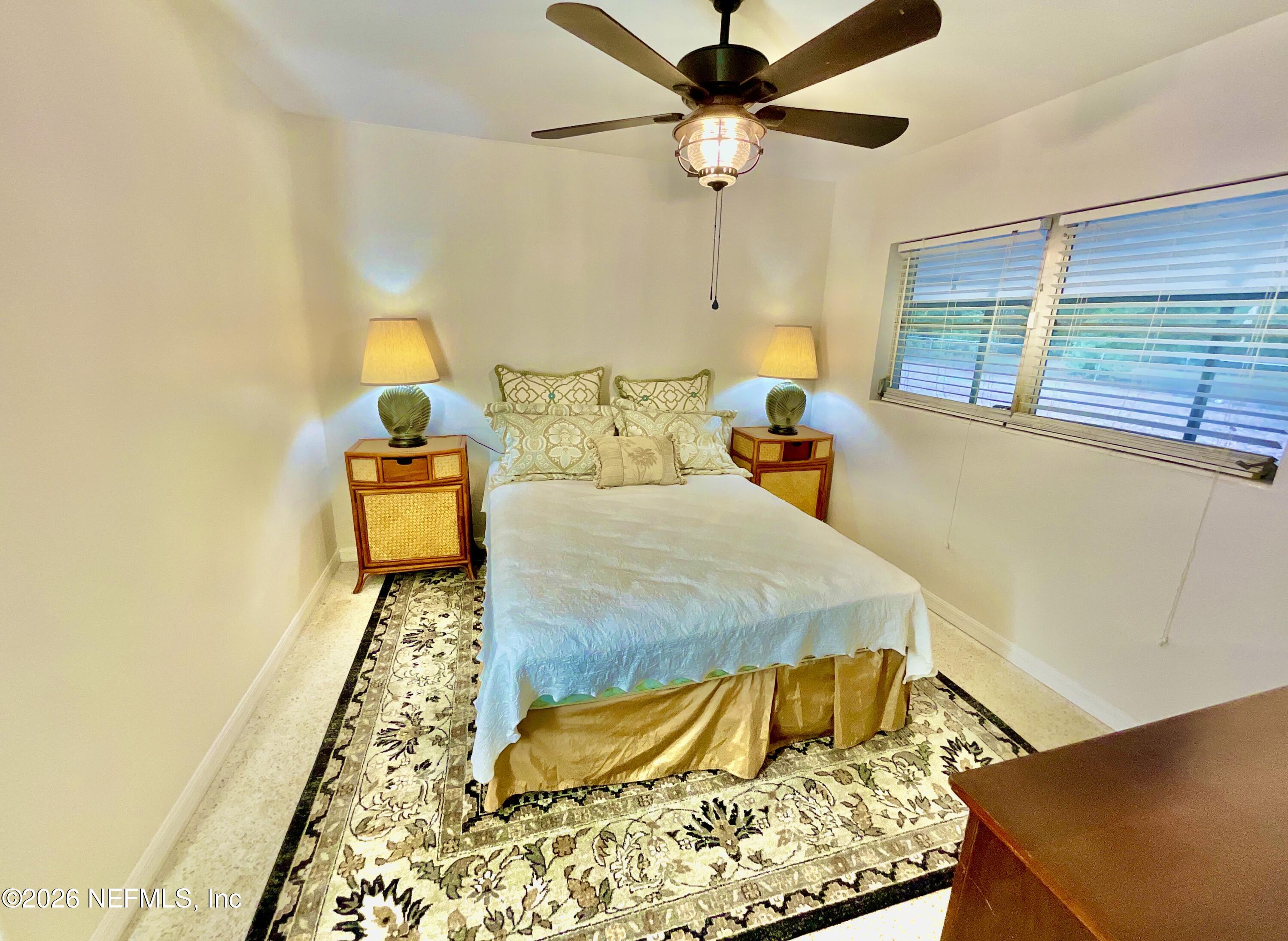 17221 Northeast 77th Lane Hawthorne, FL 32640 - Photo 32 of 59 a bed sitting in a bedroom next to a window