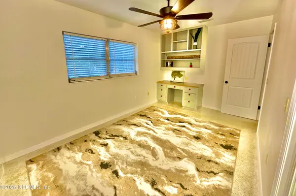 a bedroom with a bed and ceiling fan