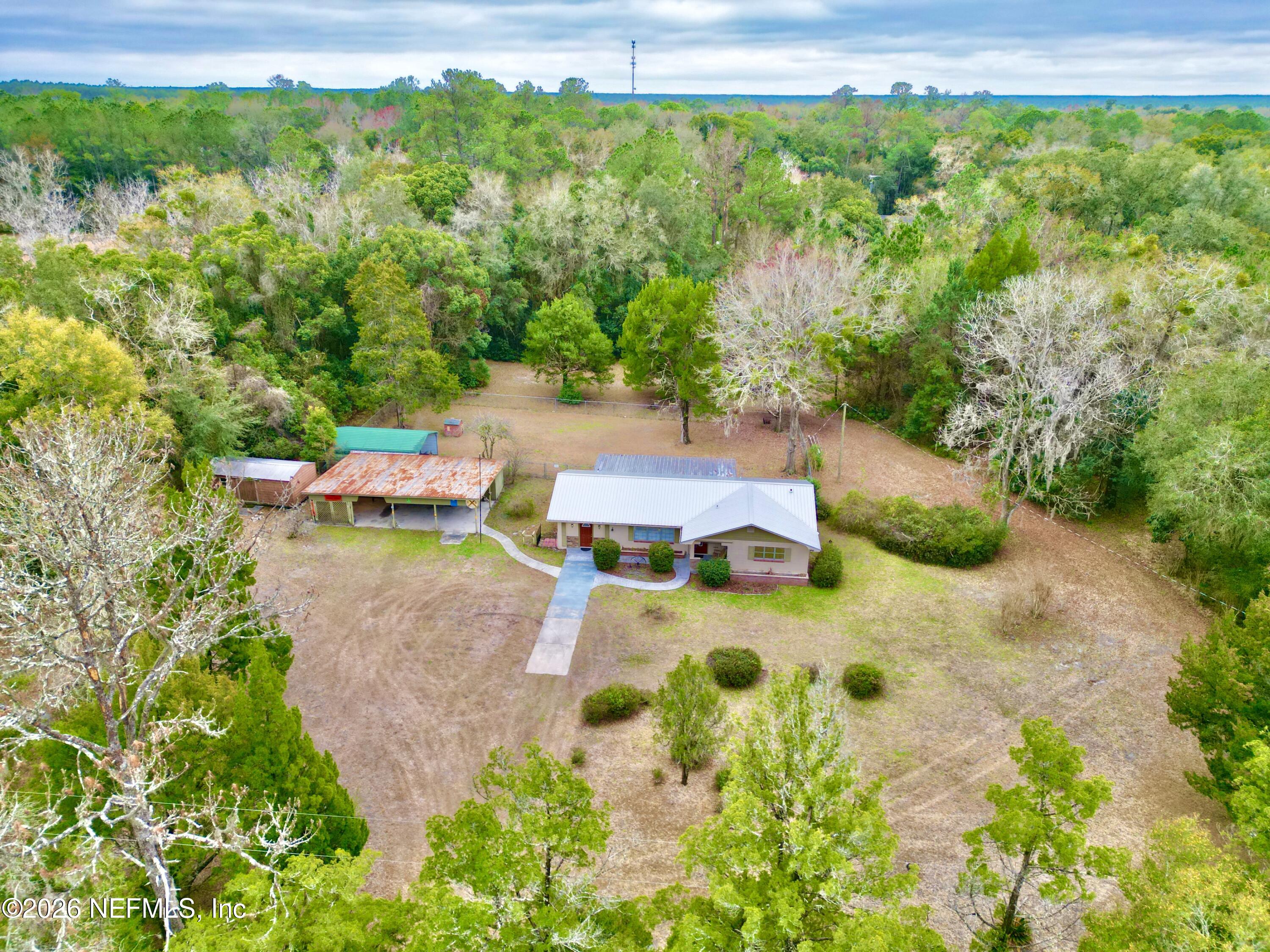 17221 Northeast 77th Lane Hawthorne, FL 32640 - Photo 4 of 59 an aerial view of a house with swimming pool and garden view