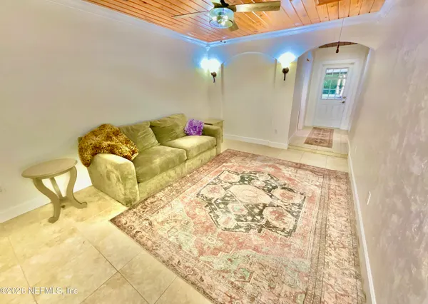 a living room with large trees and a table