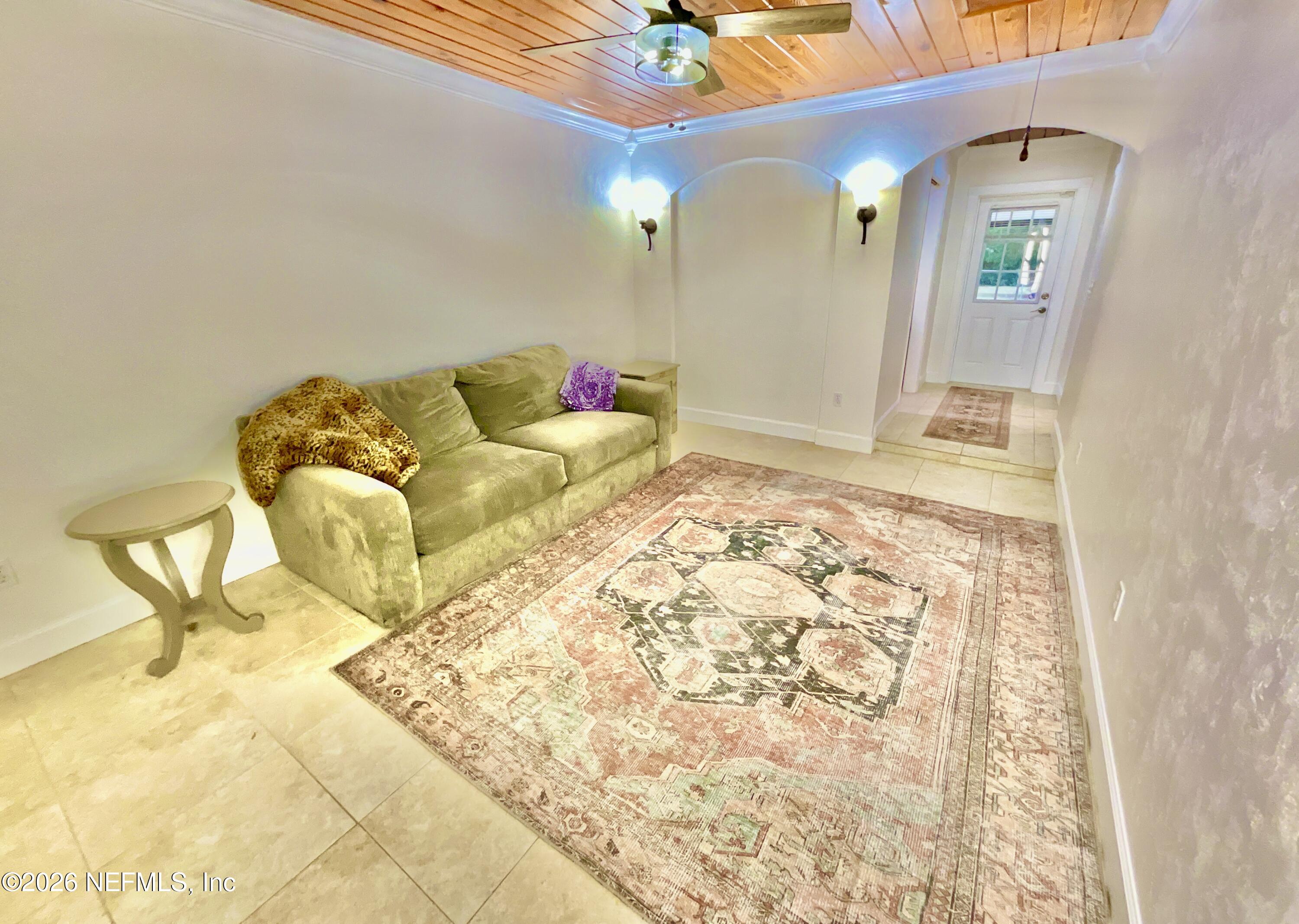 17221 Northeast 77th Lane Hawthorne, FL 32640 - Photo 41 of 59 a bedroom with a bed and a chandelier