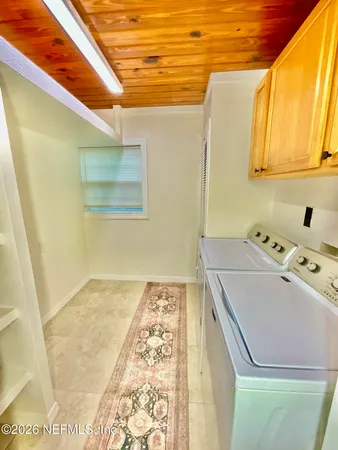 a view of a dining area with furniture and a floor to ceiling window
