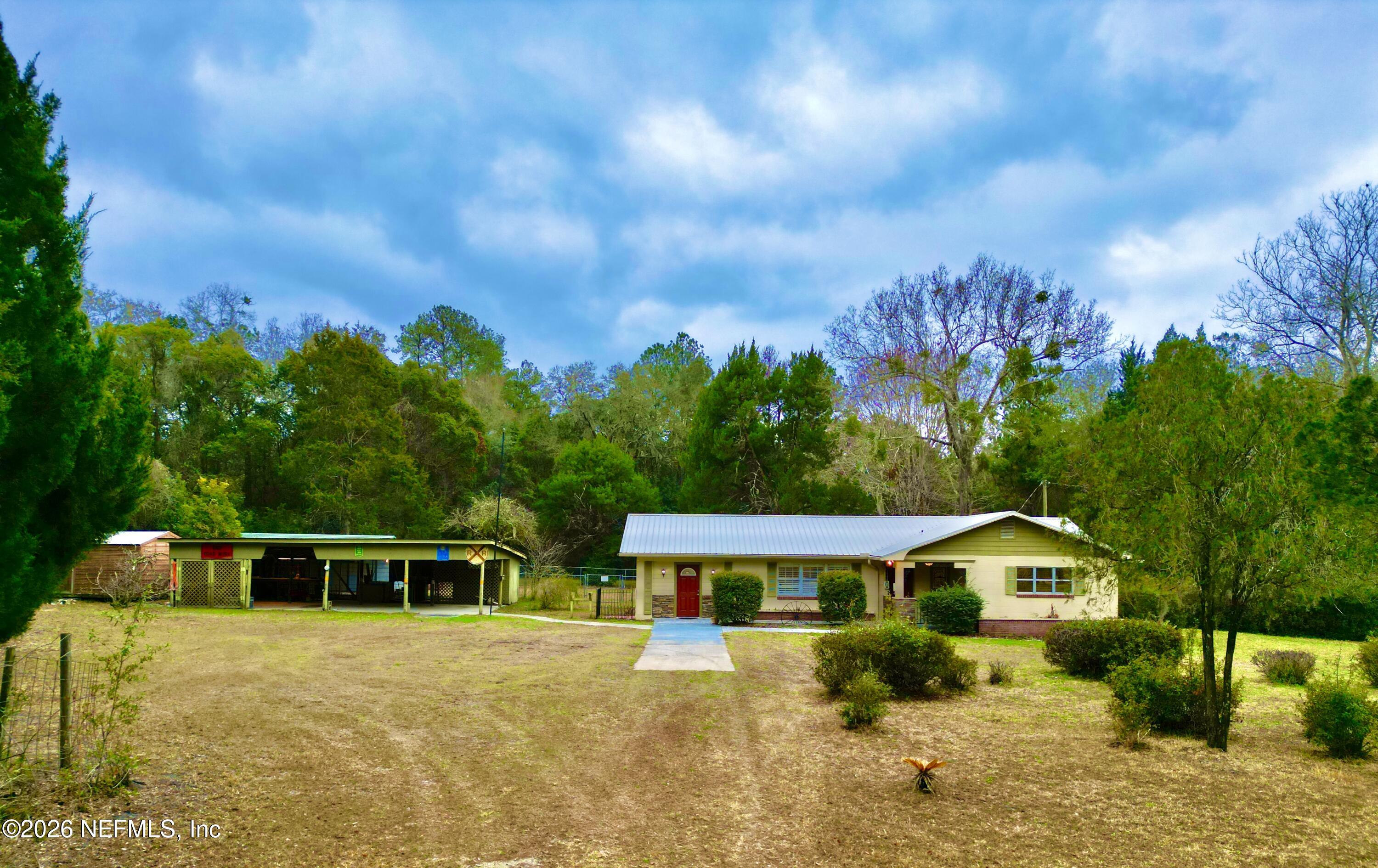 17221 Northeast 77th Lane Hawthorne, FL 32640 - Photo 5 of 59 a front view of a house with a yard