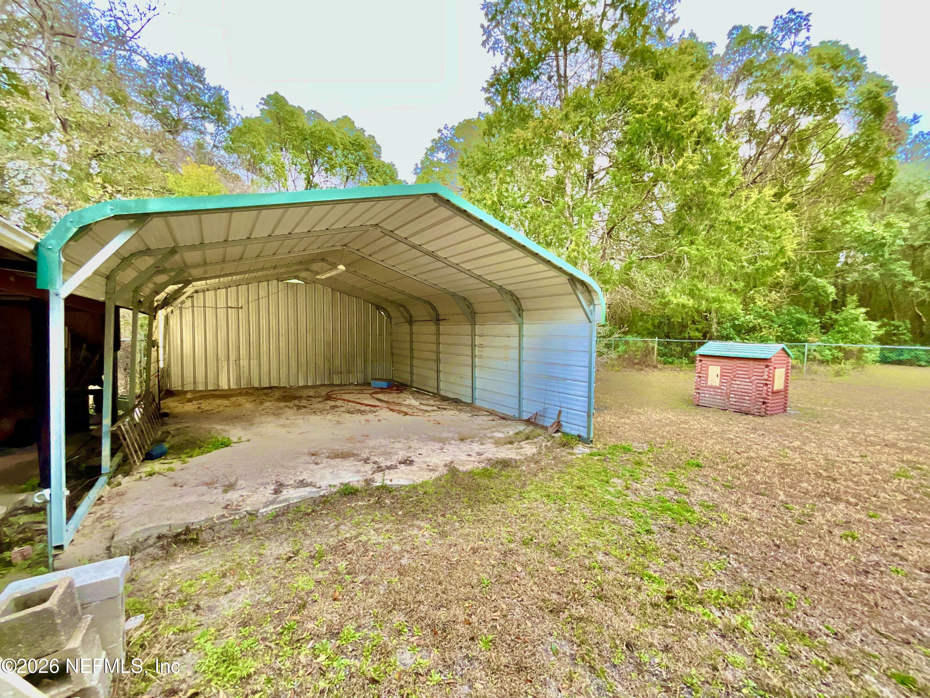 17221 Northeast 77th Lane Hawthorne, FL 32640 - Photo 53 of 59 a front view of a house with a yard