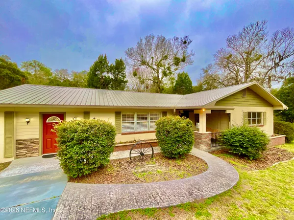 a house with green field in front of it