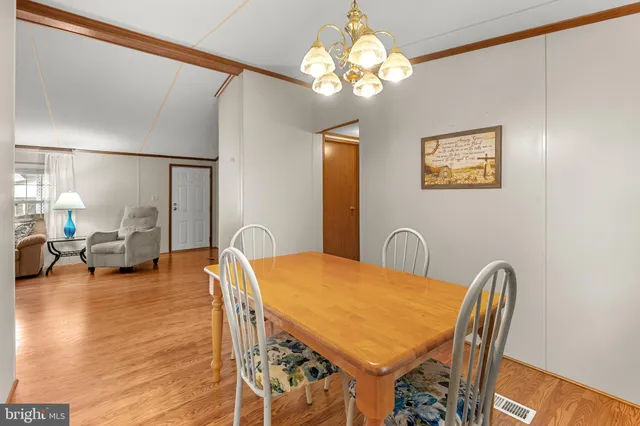 a view of a dining room with furniture and chandelier