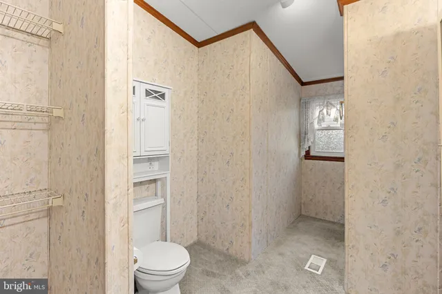 a bathroom with a toilet a sink and shower