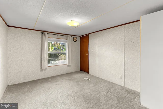 a bathroom with a granite countertop sink a toilet a mirror and shower