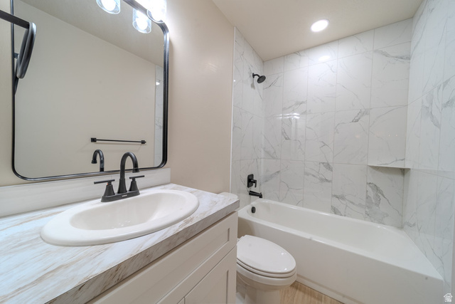 130 Pole Line Road, Unit 2 Roosevelt, UT 84066 - Photo 25 of 33 Bathroom featuring a white bathtub with a tile surround, built-in tile niche, and matte black fixtures