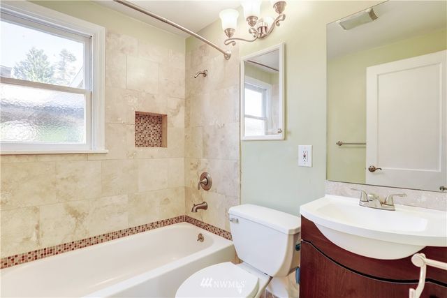 a bathroom with a sink mirror toilet and bathtub