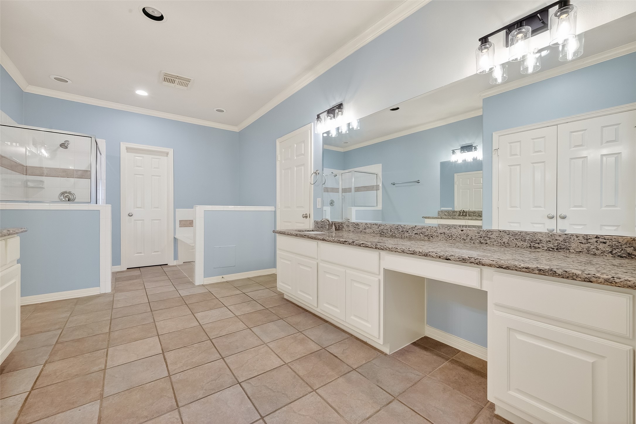 5835 Val Verde Street Houston, TX 77057 - Photo 16 of 21 a large bathroom with a granite countertop sink and a mirror