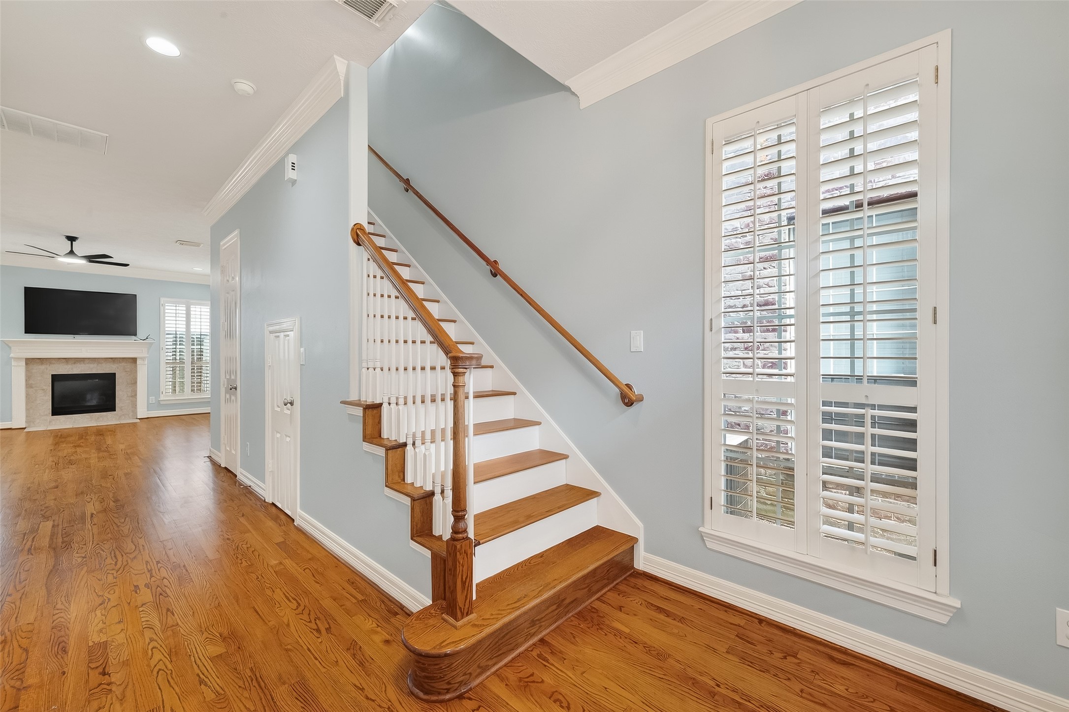 5835 Val Verde Street Houston, TX 77057 - Photo 3 of 21 a view of a hallway with wooden floor and staircase
