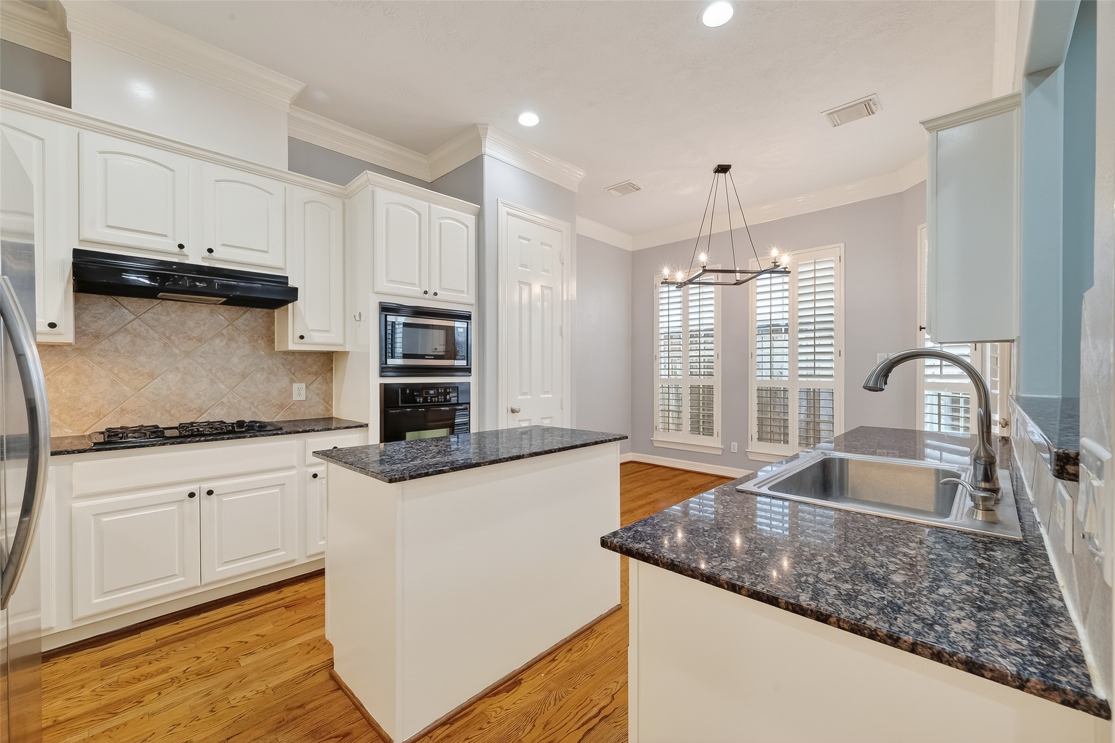 5835 Val Verde Street Houston, TX 77057 - Photo 8 of 21 a kitchen with granite countertop a sink stove and cabinets