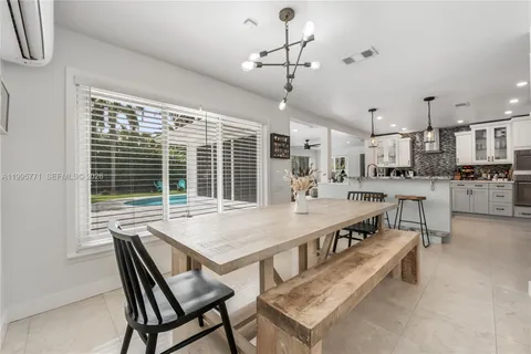 a large kitchen with a table and chairs
