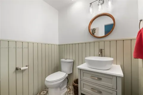 a bathroom with a toilet a sink and a mirror