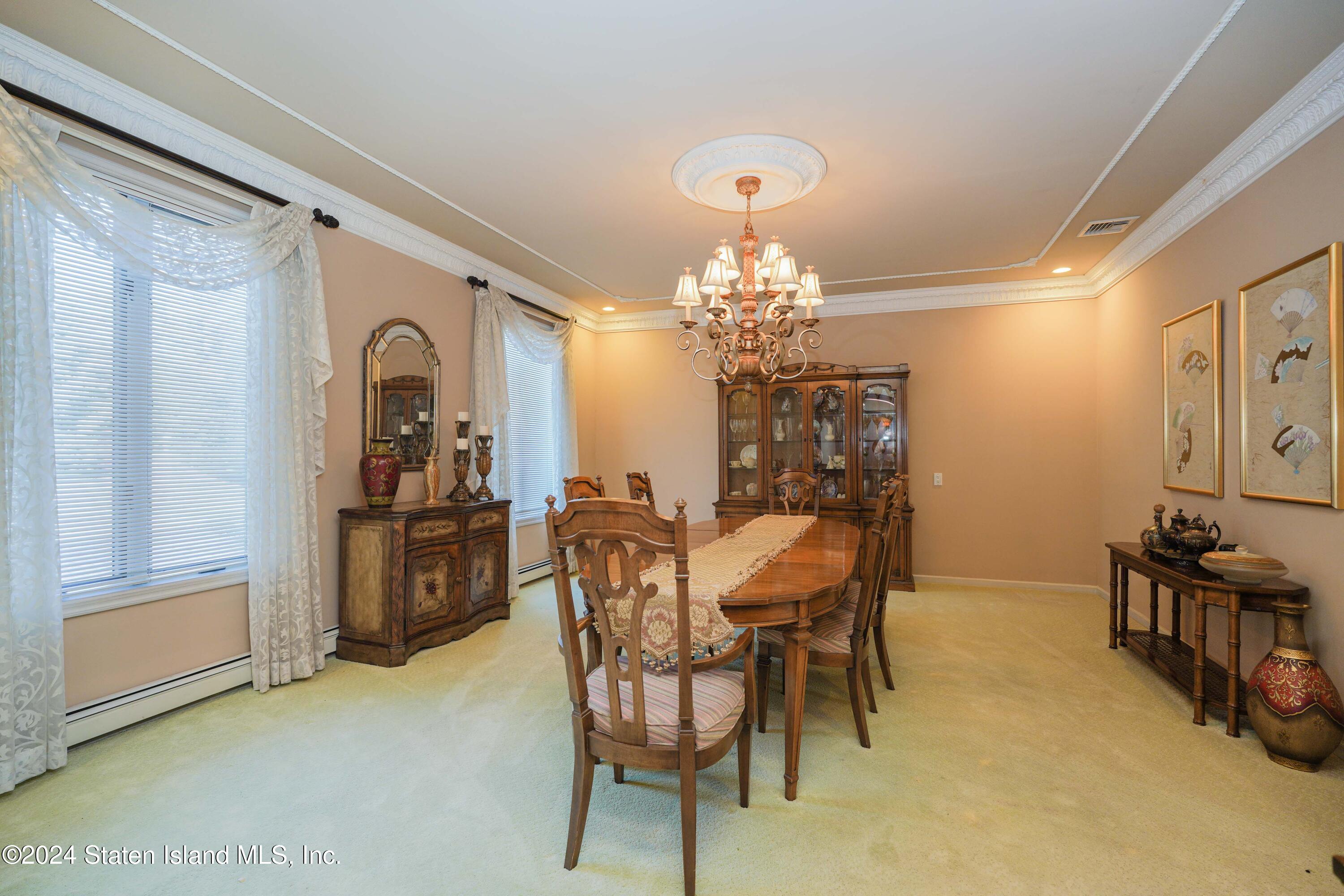12 Romer Road Staten Island, NY 10304 - Photo 11 of 63 a view of a dining room with furniture and chandelier