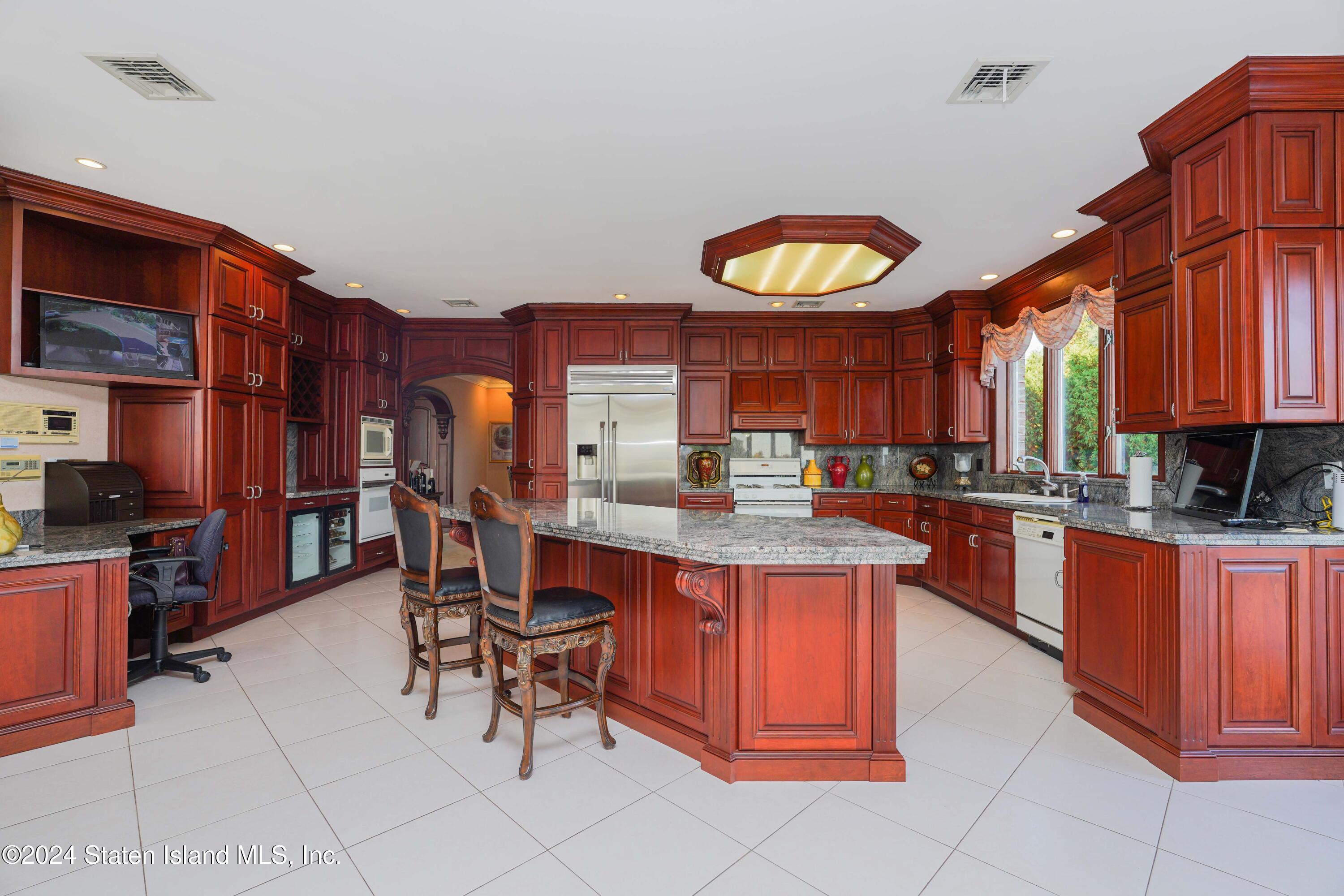 12 Romer Road Staten Island, NY 10304 - Photo 16 of 63 a kitchen with stainless steel appliances granite countertop a stove a sink dishwasher and cabinets with wooden floor