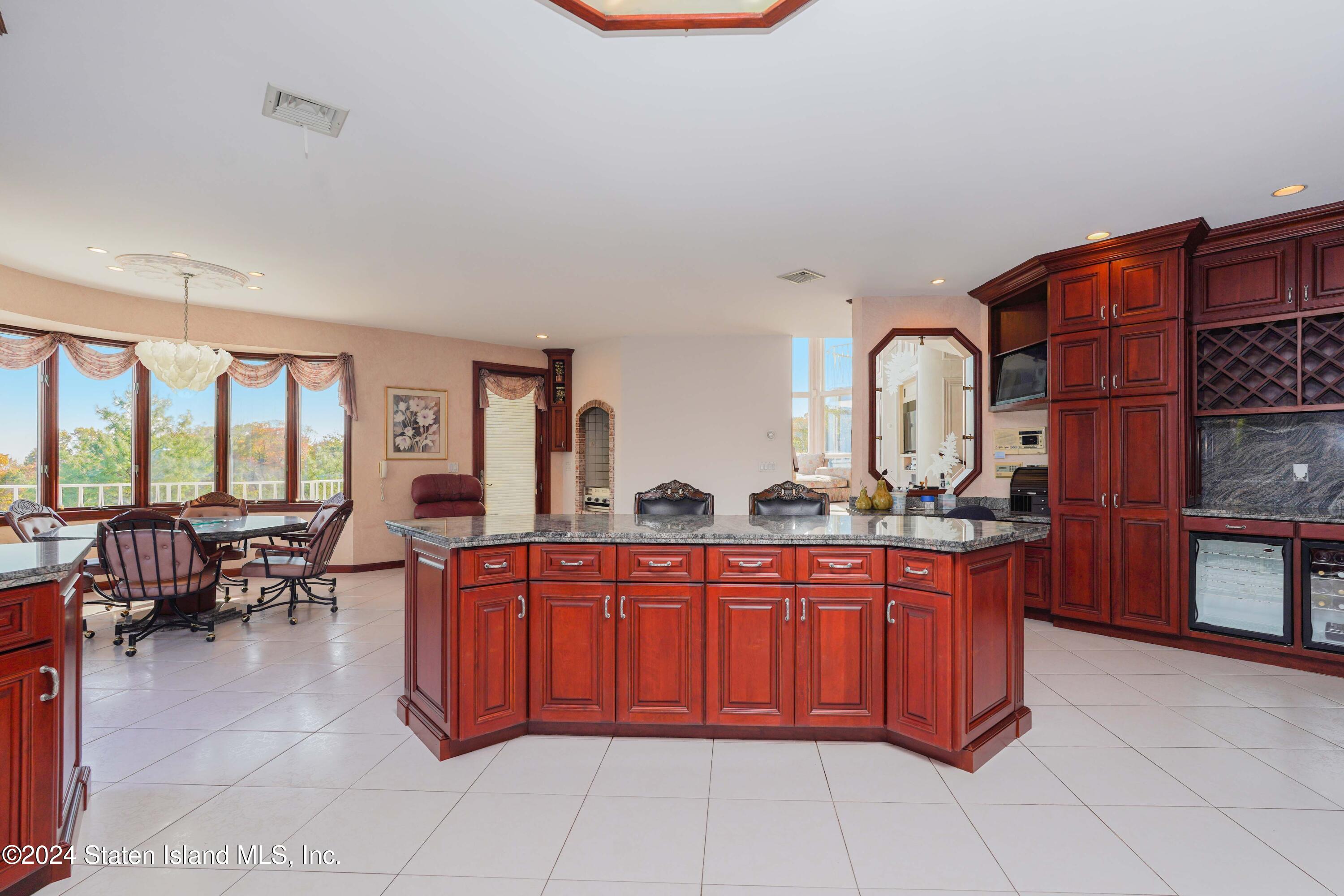 12 Romer Road Staten Island, NY 10304 - Photo 17 of 63 a large kitchen with stainless steel appliances a sink and cabinets