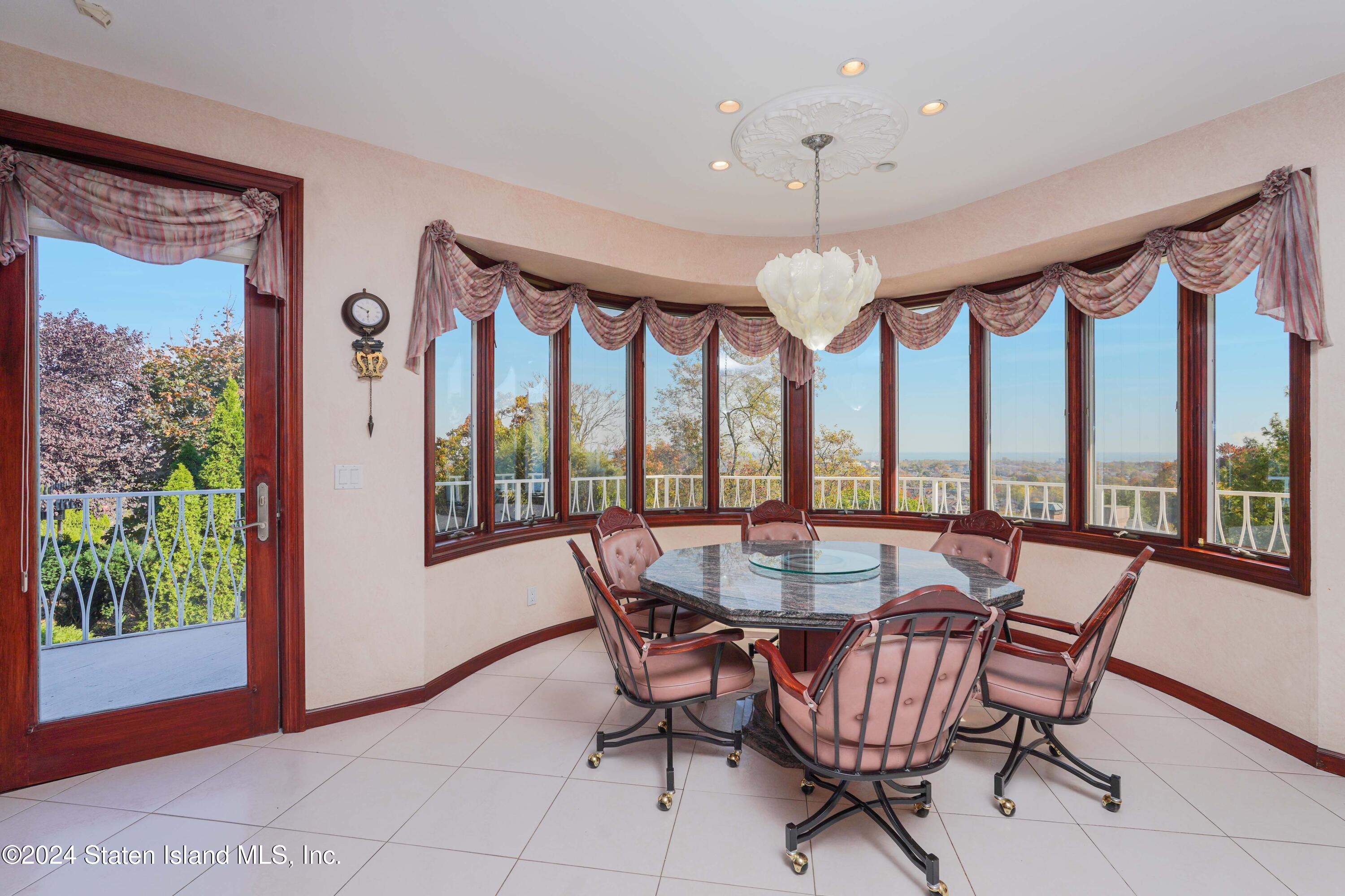 12 Romer Road Staten Island, NY 10304 - Photo 18 of 63 a dining room with furniture water view and a floor to ceiling window