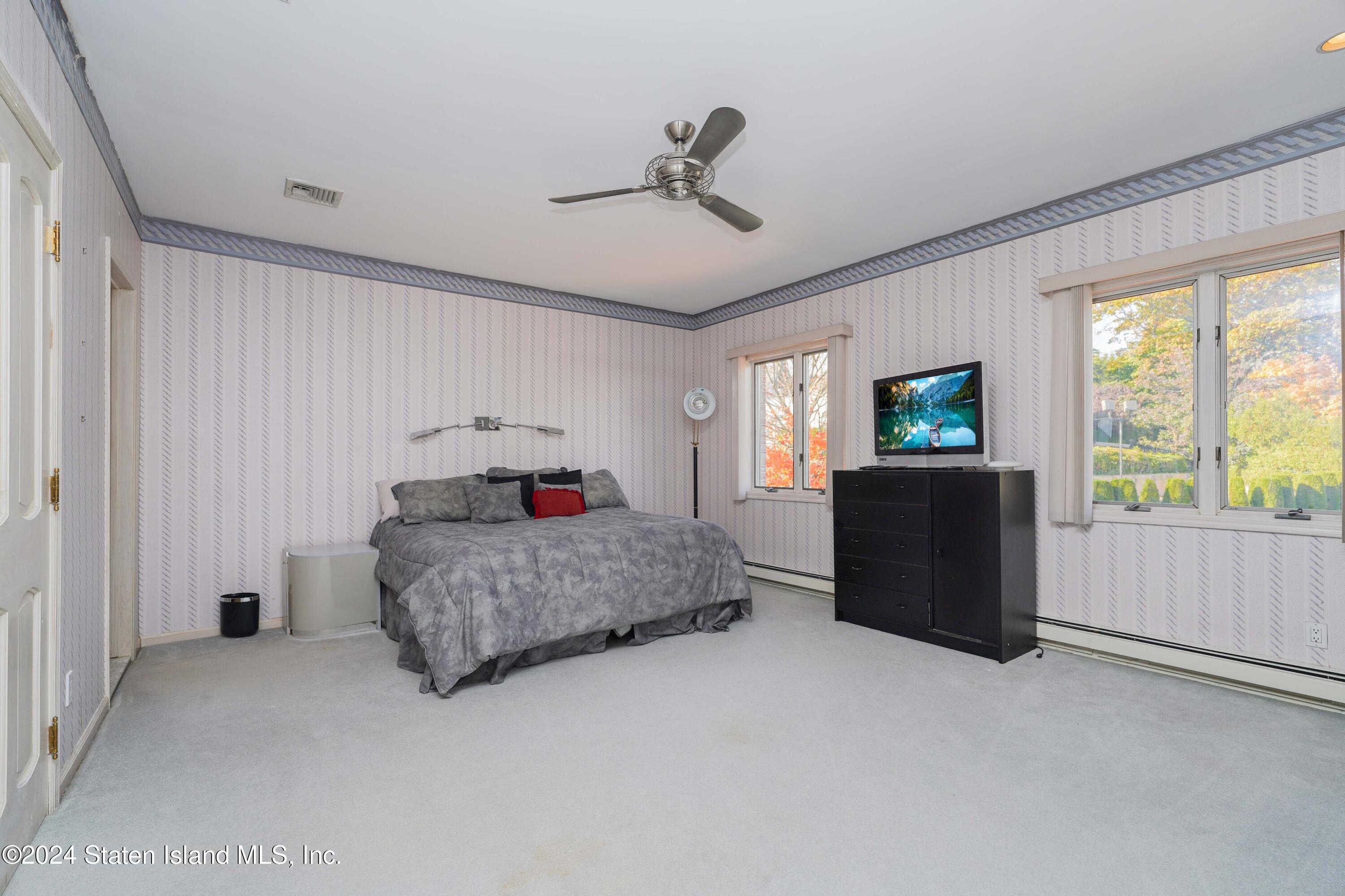 12 Romer Road Staten Island, NY 10304 - Photo 39 of 63 a living room with furniture a flat screen tv and a large window
