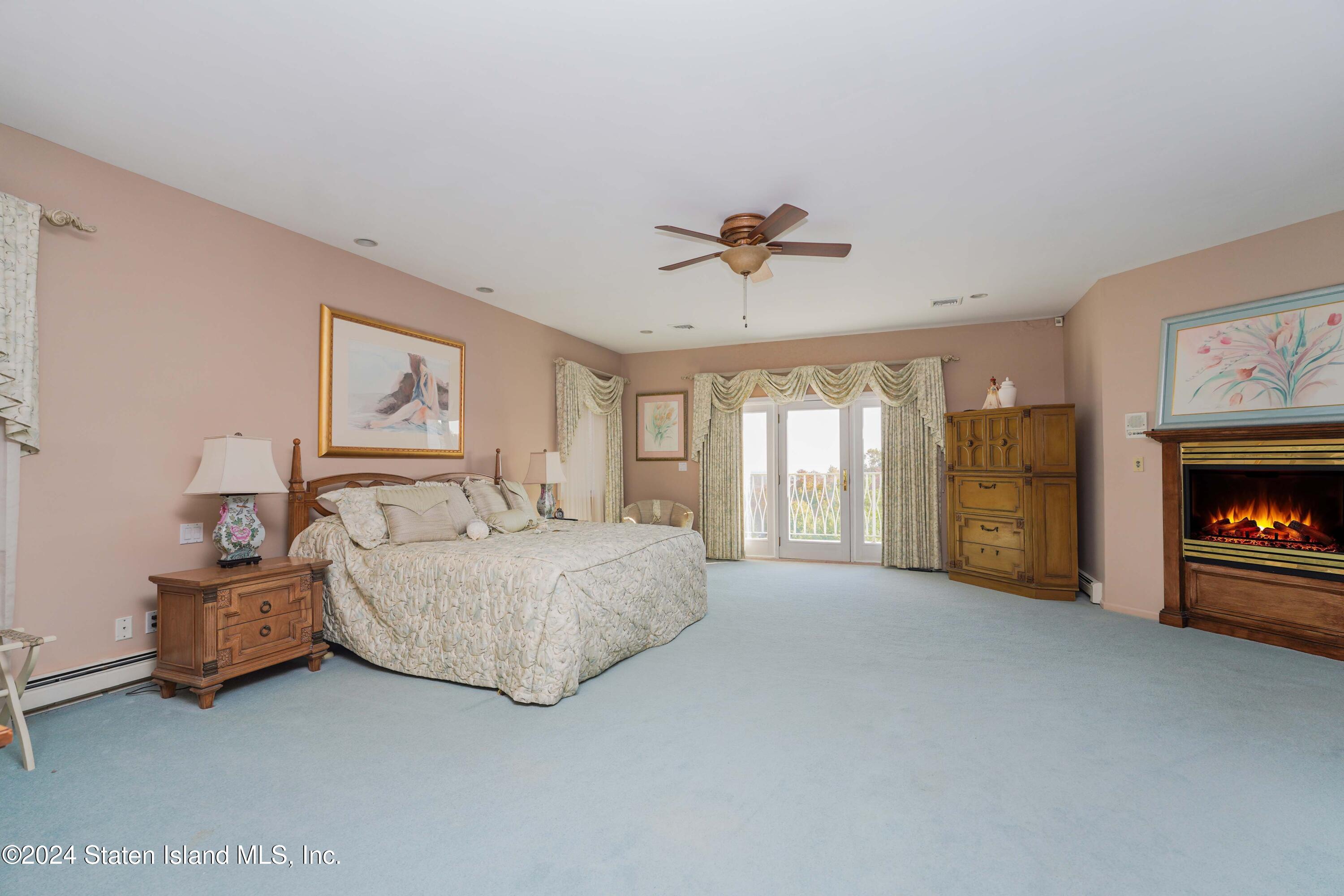 12 Romer Road Staten Island, NY 10304 - Photo 44 of 63 a spacious bedroom with a bed and a fireplace