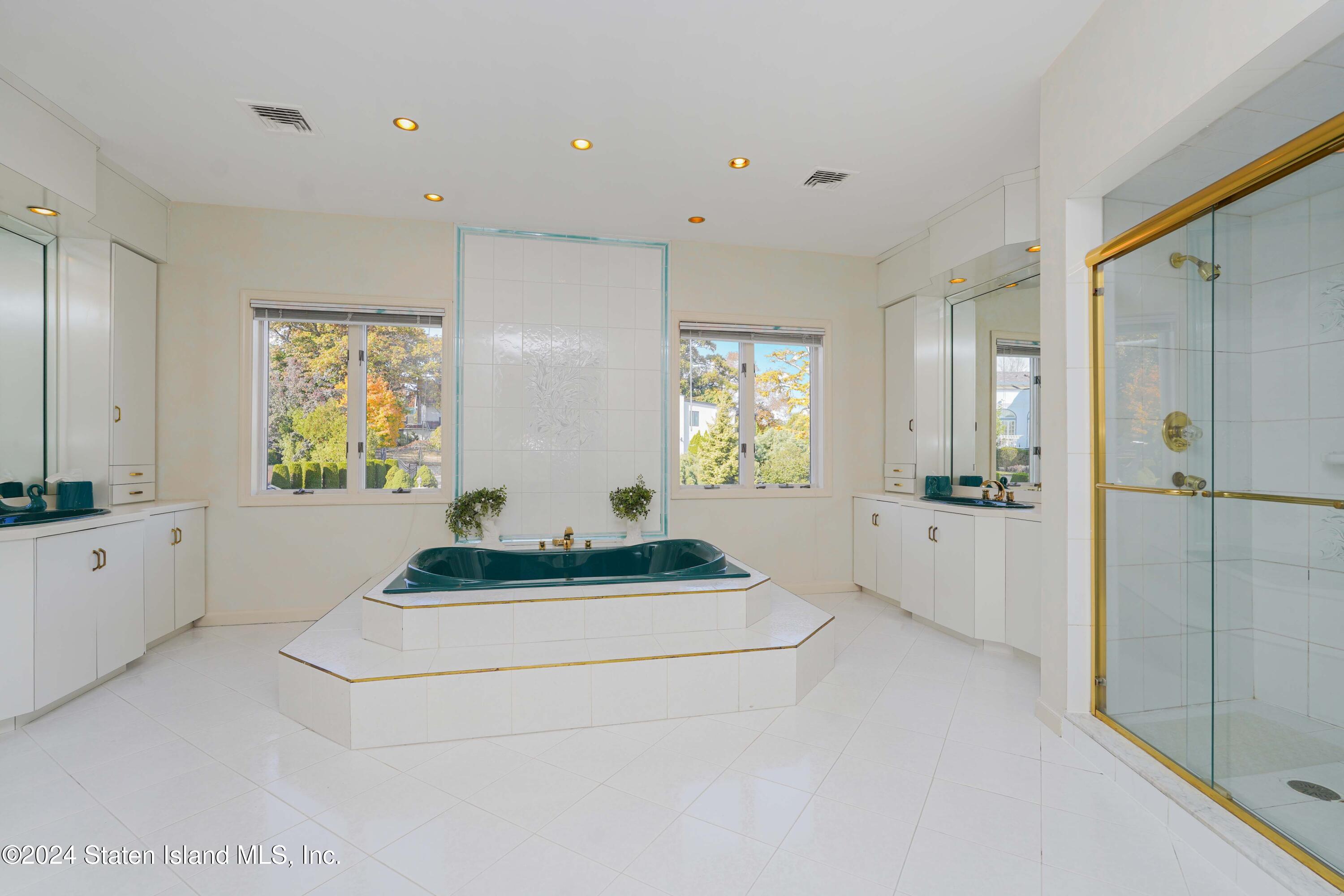 12 Romer Road Staten Island, NY 10304 - Photo 46 of 63 a spacious bedroom with a bed and a mirror