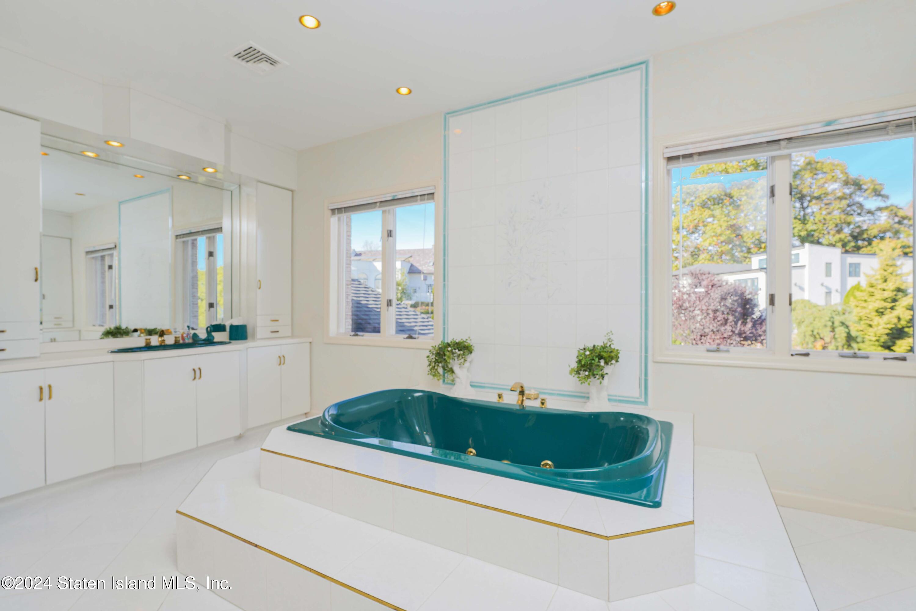 12 Romer Road Staten Island, NY 10304 - Photo 47 of 63 a bathroom with a bathtub a sink and a window