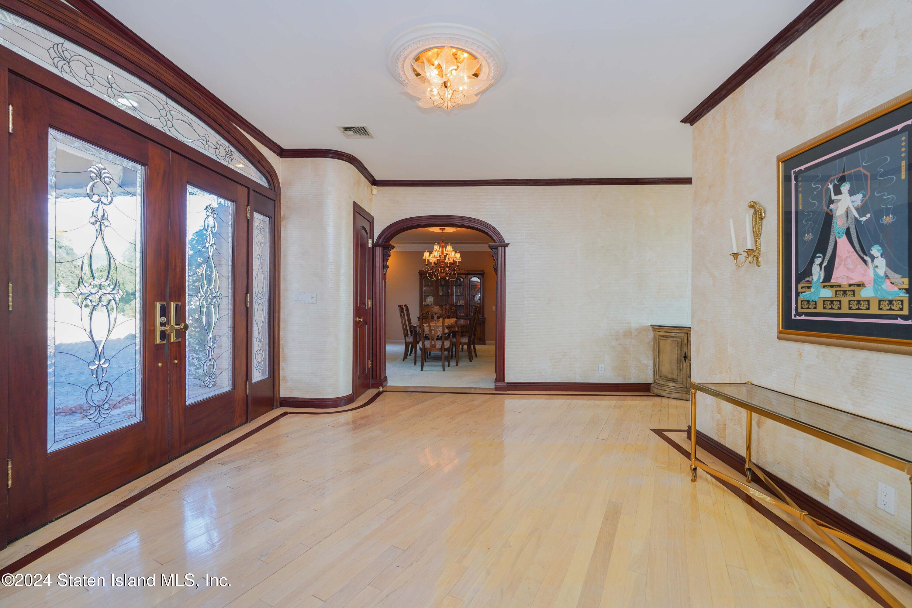 12 Romer Road Staten Island, NY 10304 - Photo 9 of 63 a view of a room with gym equipment and large windows