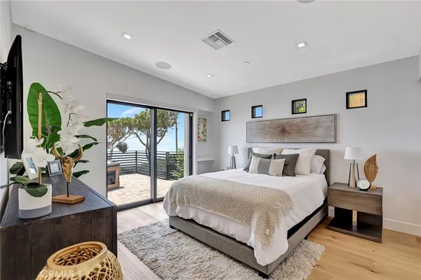 a bedroom with a large bed and a window
