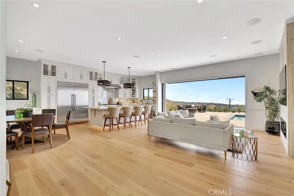 a kitchen with stainless steel appliances kitchen island granite countertop a stove a sink and a microwave