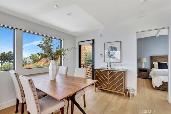 a view of a dining room with furniture window and wooden floor