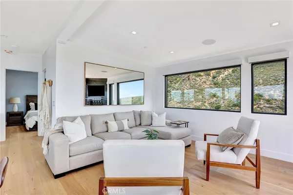 a living room with furniture and large windows