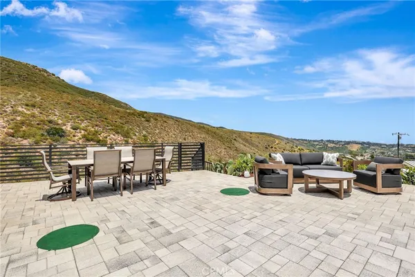a kitchen with stainless steel appliances kitchen island granite countertop a refrigerator a sink and white cabinets