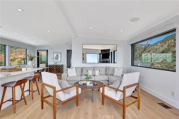 a living room with a flat screen tv and a floor to ceiling window