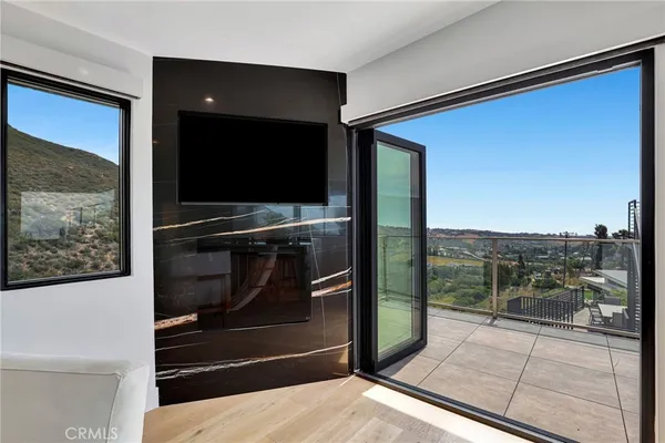 a bedroom with a large bed and a flat screen tv