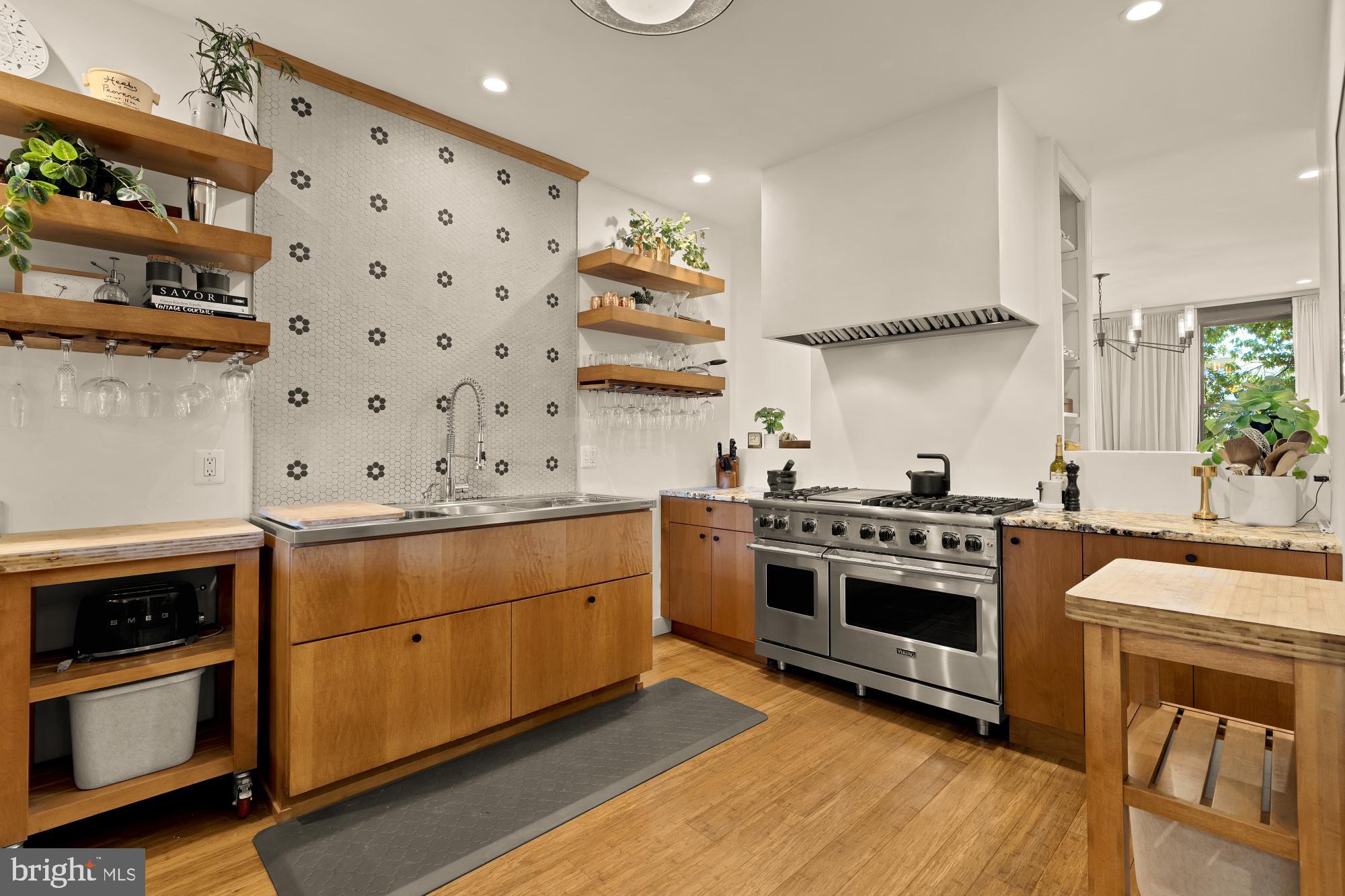 951 14th Street Southeast Washington, DC 20003 - Photo 12 of 50 a kitchen with cabinets stainless steel appliances and wooden floor