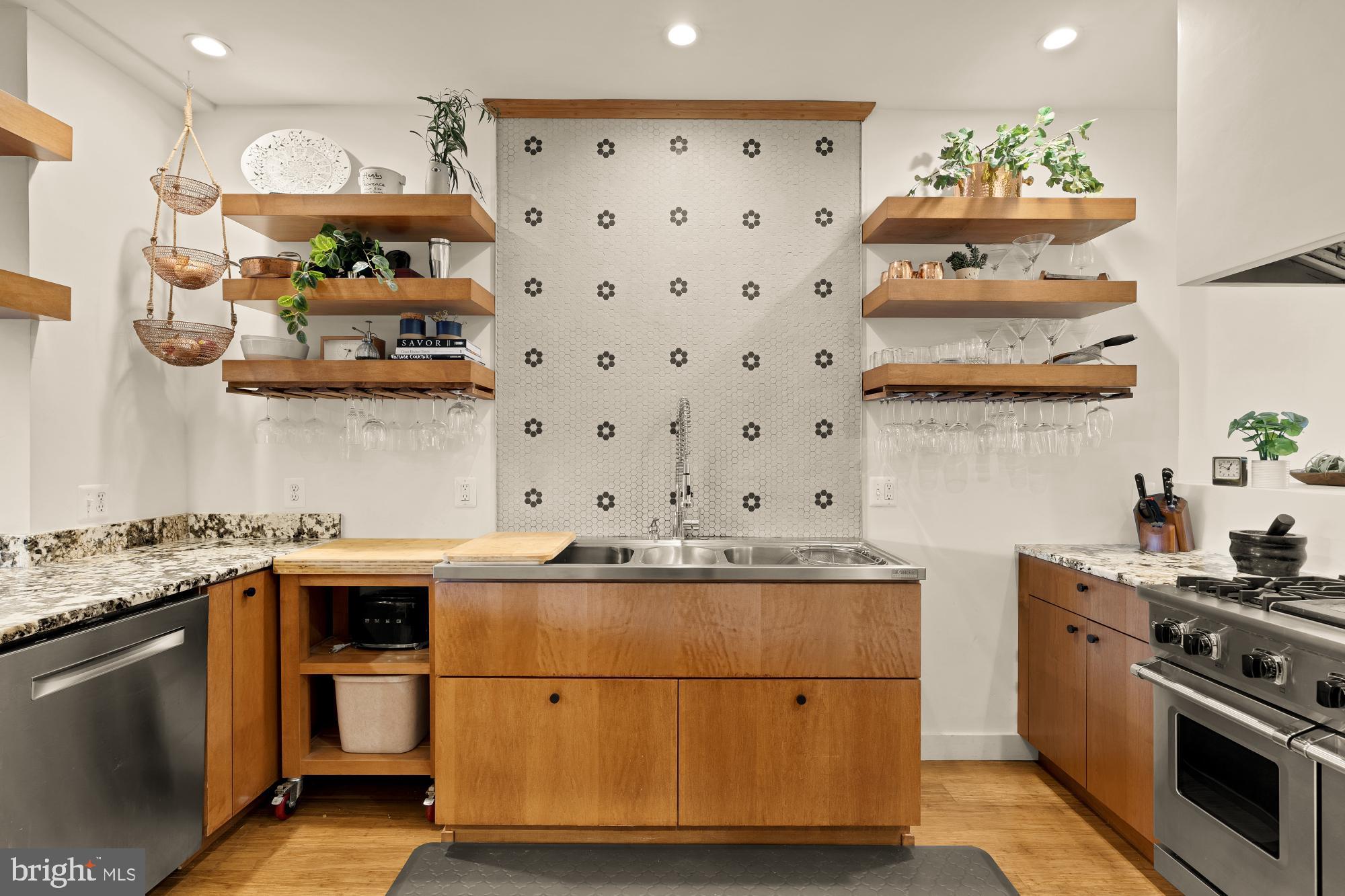 951 14th Street Southeast Washington, DC 20003 - Photo 13 of 50 a kitchen with stainless steel appliances granite countertop a refrigerator and a stove
