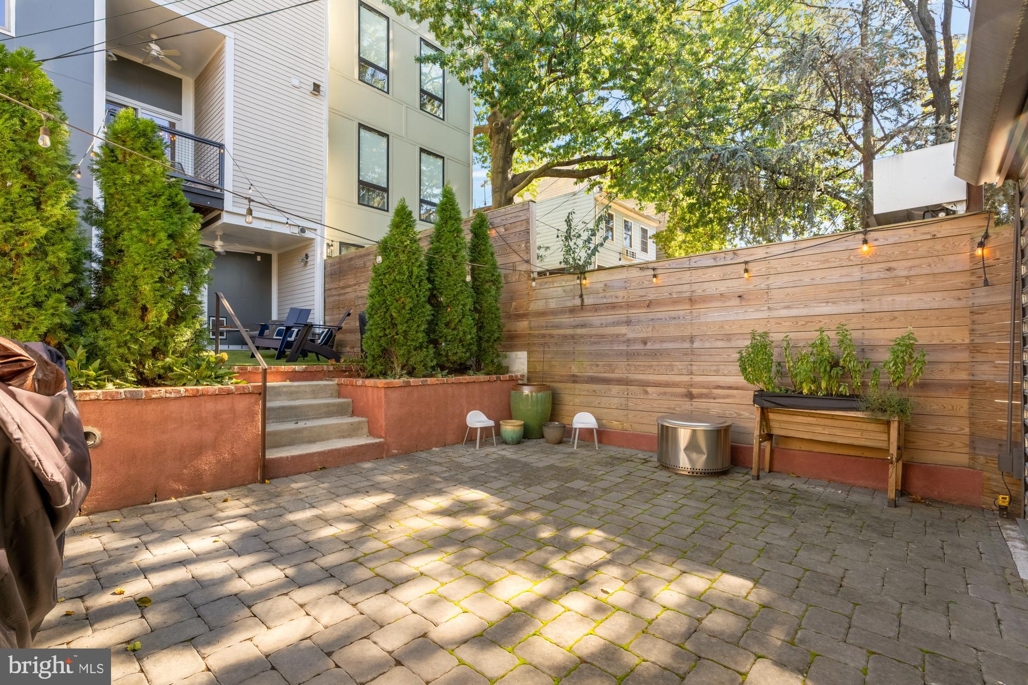 951 14th Street Southeast Washington, DC 20003 - Photo 23 of 50 a view of a backyard with chairs and a fire pit