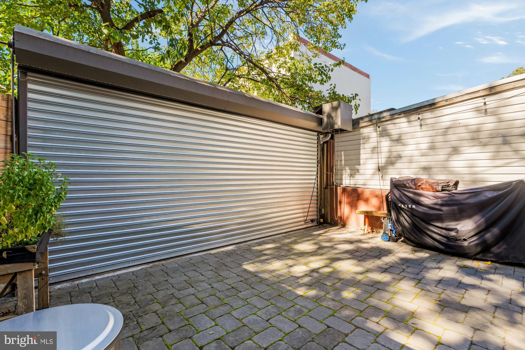 951 14th Street Southeast Washington, DC 20003 - Photo 24 of 50 a view of a backyard with a chair and potted plants