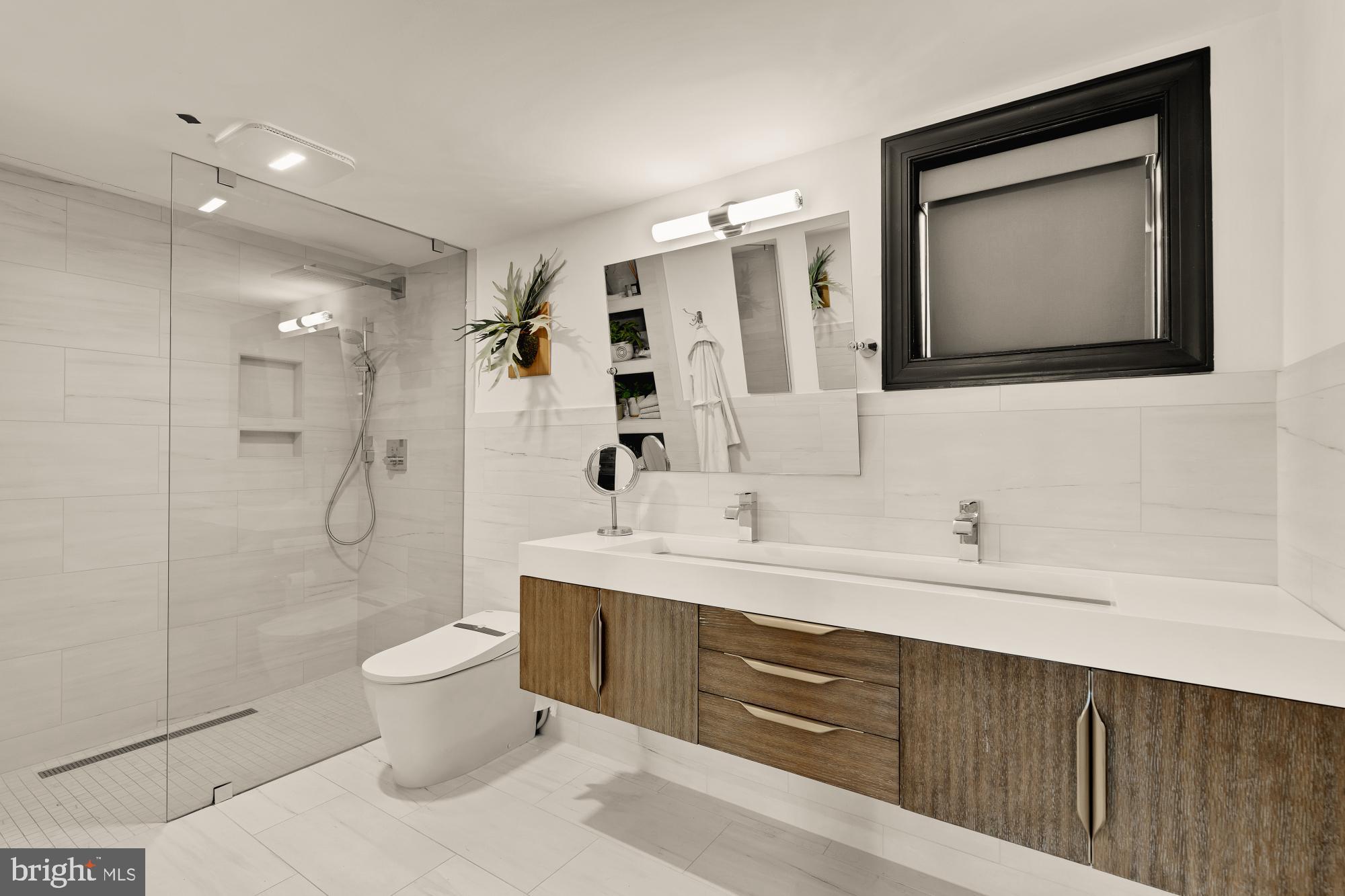951 14th Street Southeast Washington, DC 20003 - Photo 30 of 50 a spacious bathroom with a toilet sink and mirror