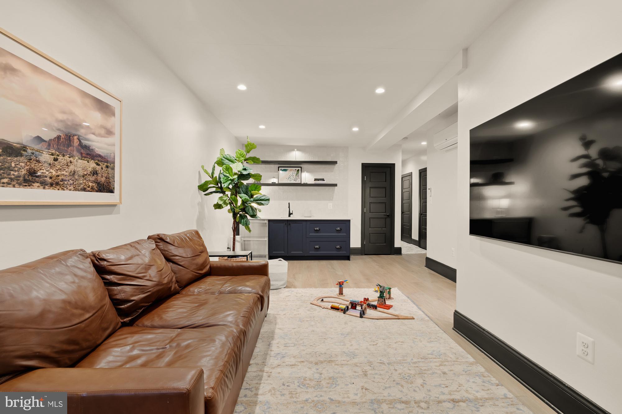 951 14th Street Southeast Washington, DC 20003 - Photo 40 of 50 a living room with furniture and a flat screen tv