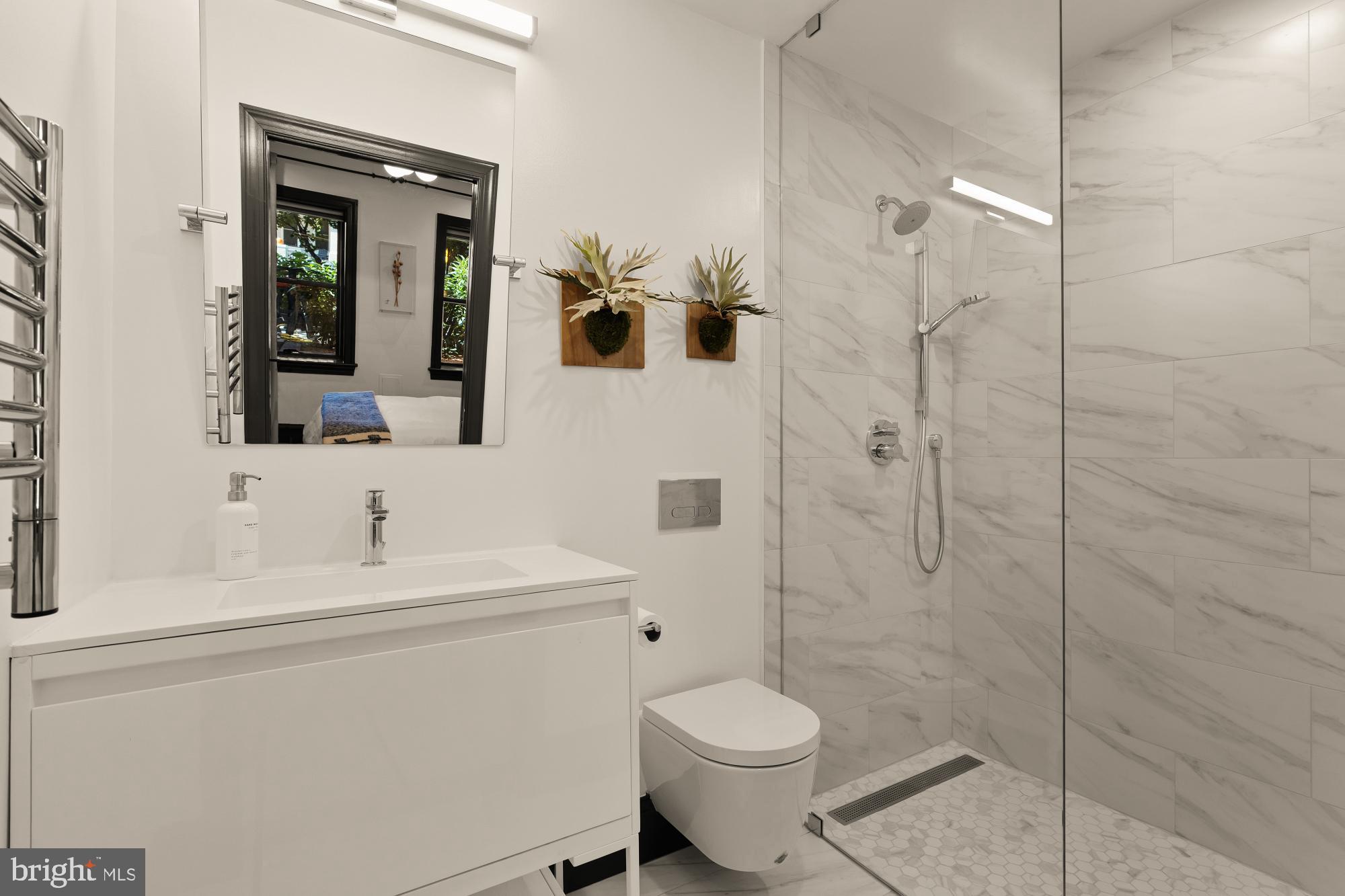 951 14th Street Southeast Washington, DC 20003 - Photo 47 of 50 a bathroom with a toilet sink a shower and mirror