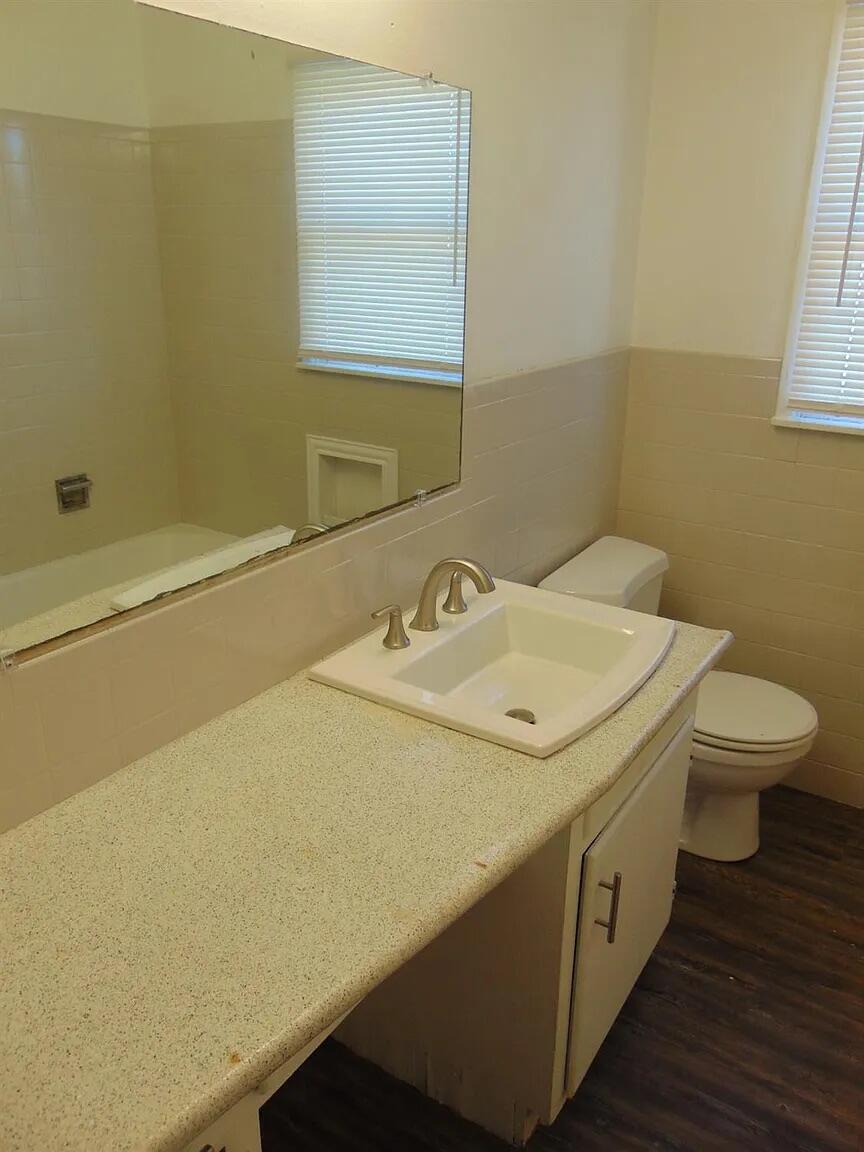 2406 46th Street, Unit A Lubbock, TX 79412 - Photo 6 of 7 a bathroom with a sink and a toilet