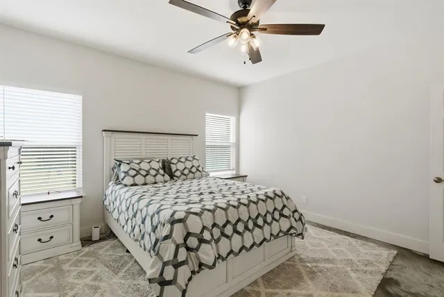 a bedroom with a large bed and a window